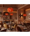 Luminaires acoustiques Curcubita orange suspendus dans un restaurant au décor chaleureux et élégant.